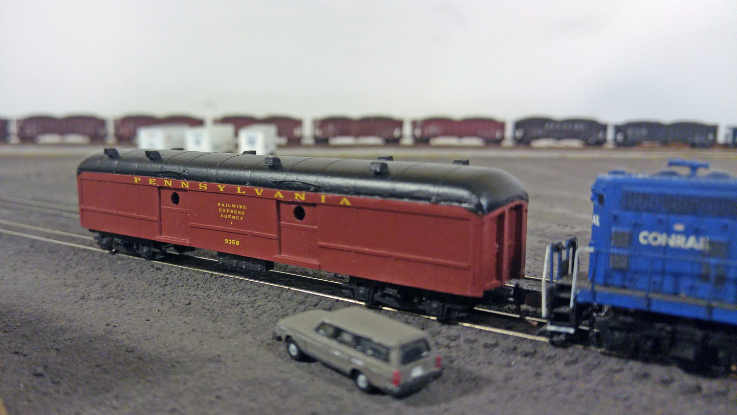 The Railwire Express Agency car arrived a few days ahead of time and has been sitting under guard on the pit track outside the yard office.